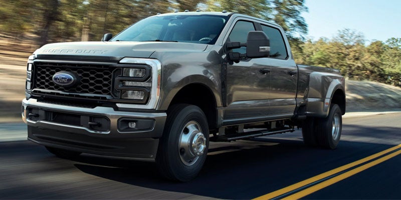 Gray Ford heavy-duty pickup truck driving on a road